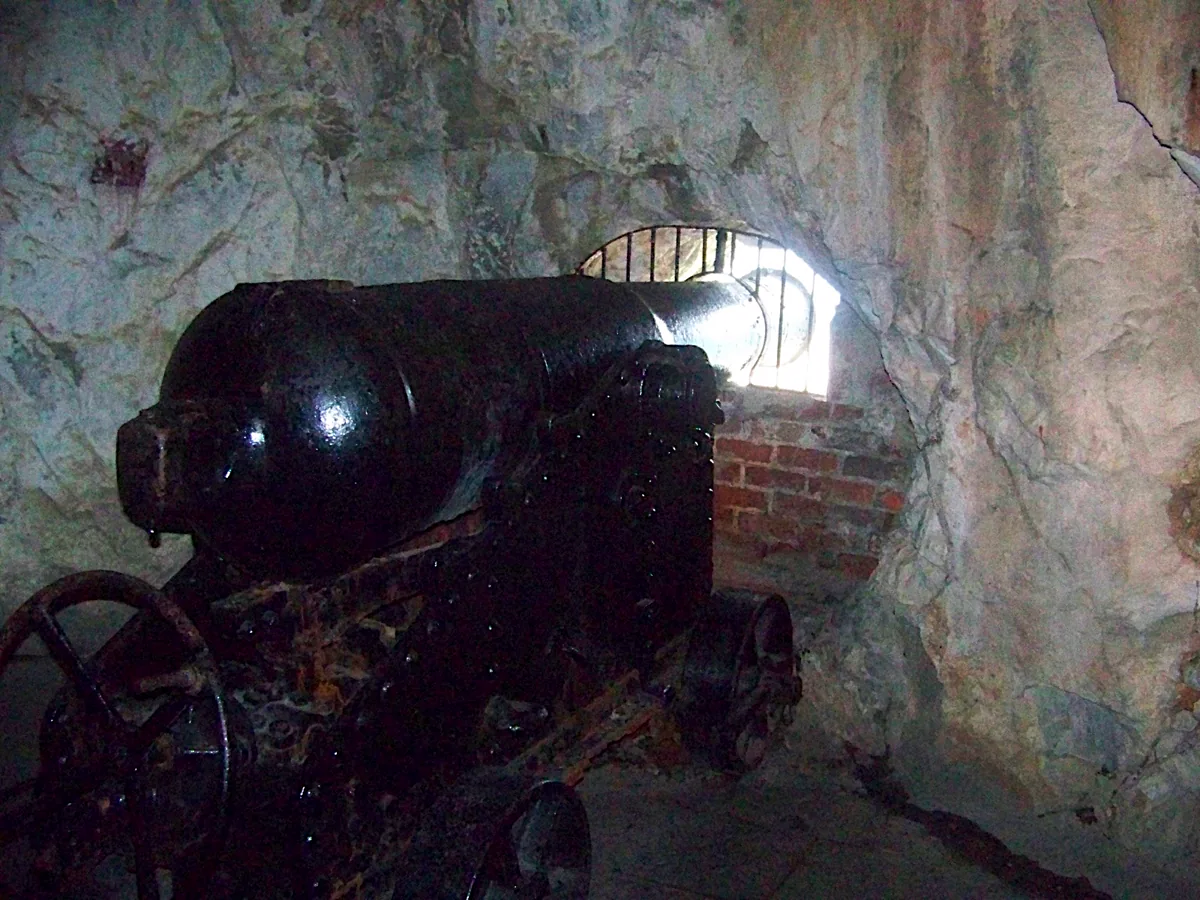Gun embrasure at the Great Siege Tunnel in the Rock of Gibraltar .