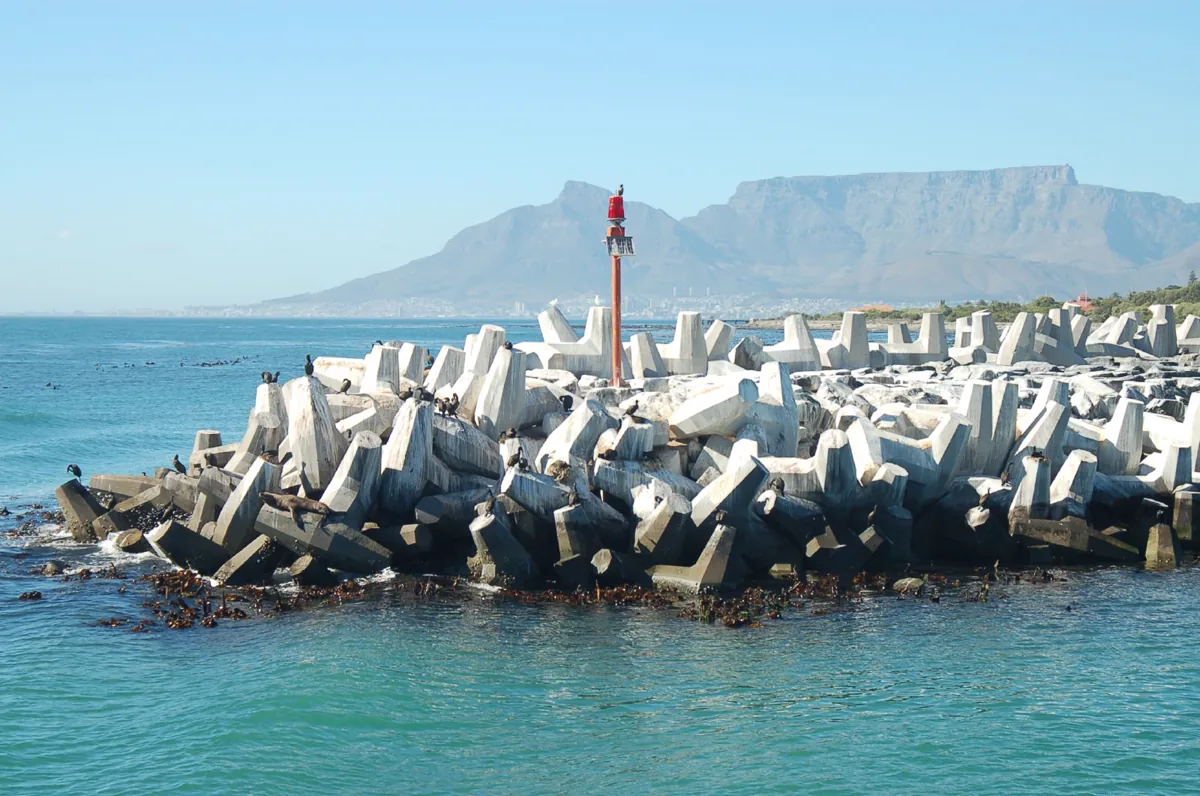 The Robben Island prison harbor breakwater. Cape Town is in the distance, behind this man-made barrier.